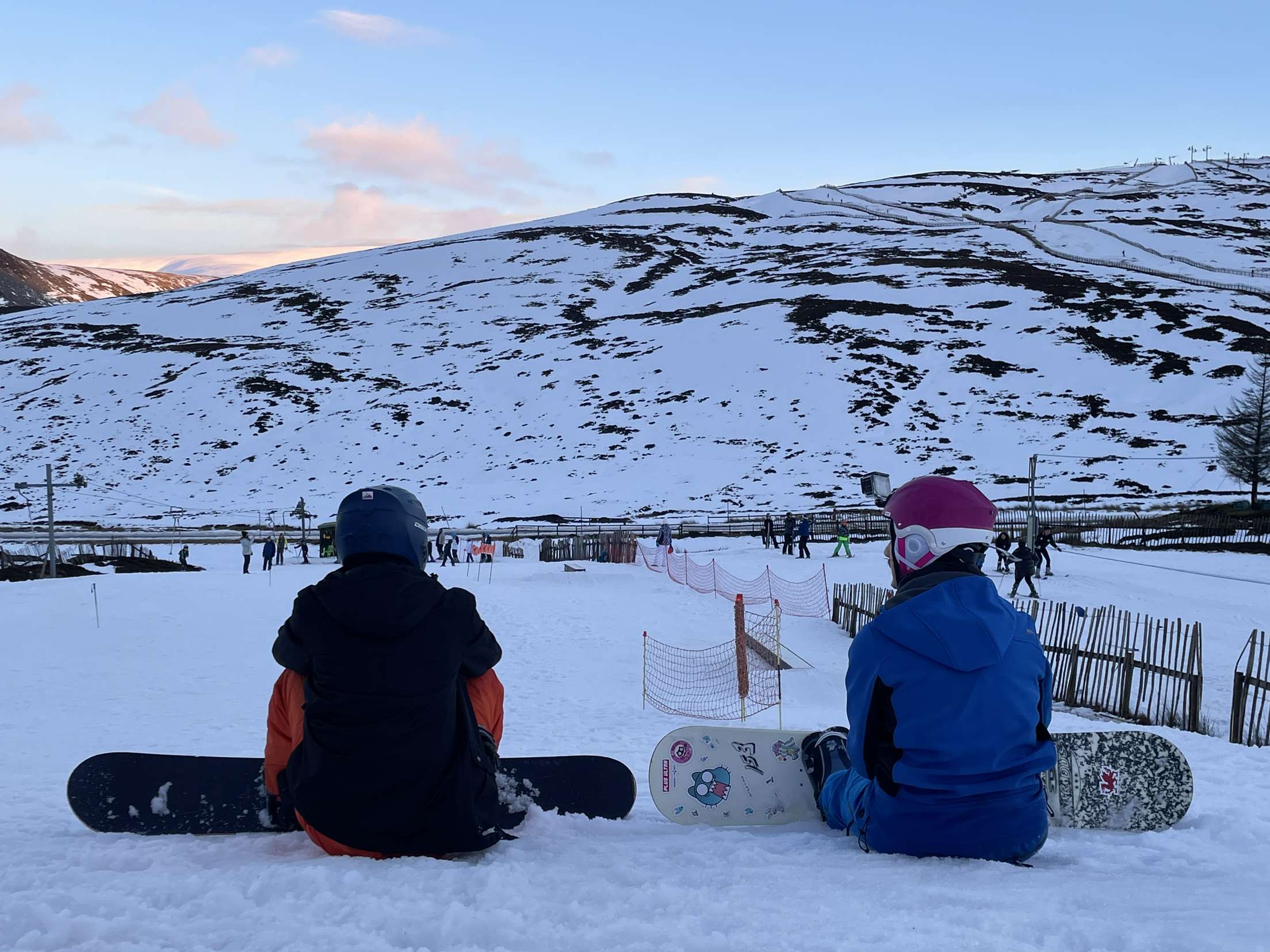 A picture of me and my boyfriend sat overlooking the snowy Cairngorms.